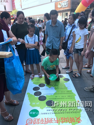 市民在宣傳點(diǎn)參加創(chuàng)文趣味游戲。 記者 朱虹 攝